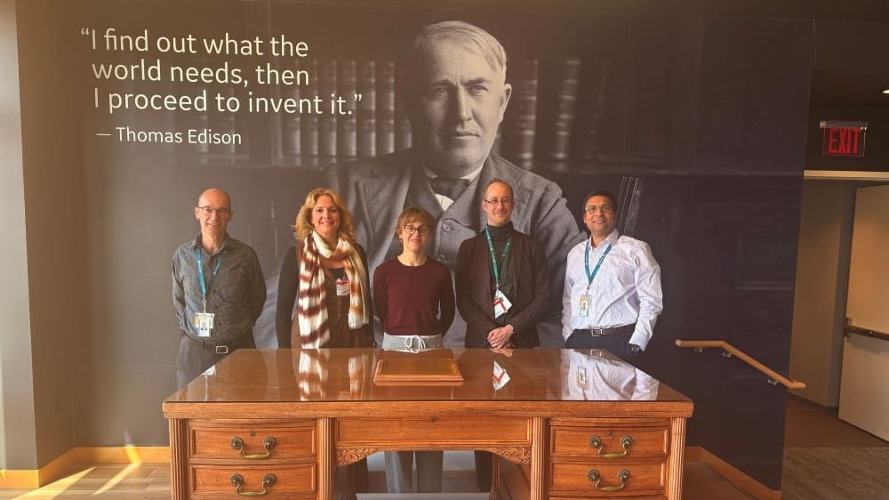 5 people standing in front of Thomas Edison image
