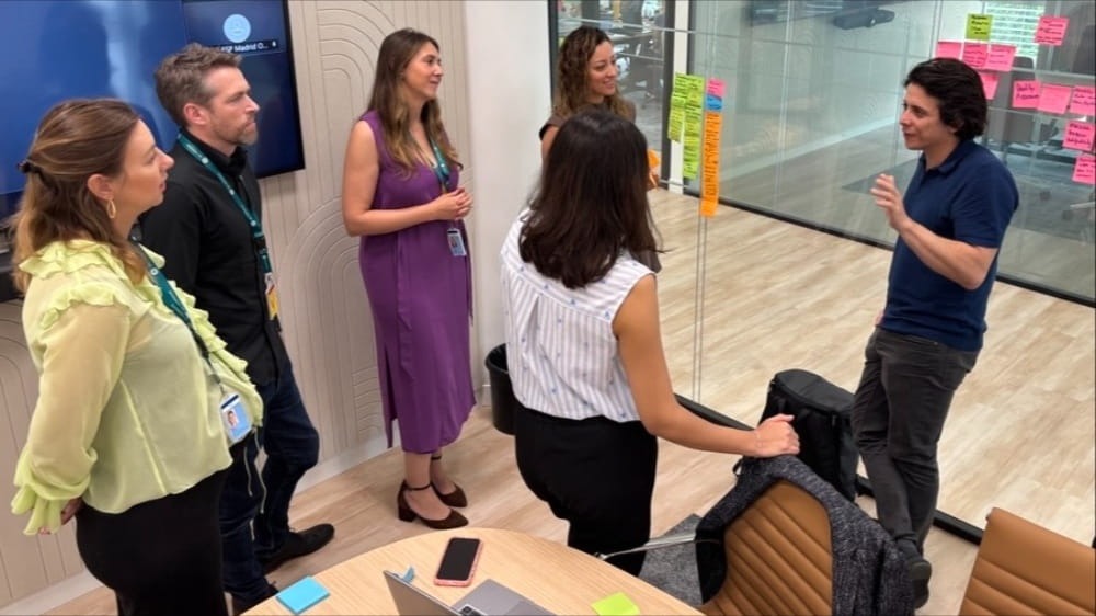 A group of people standing in a conference room