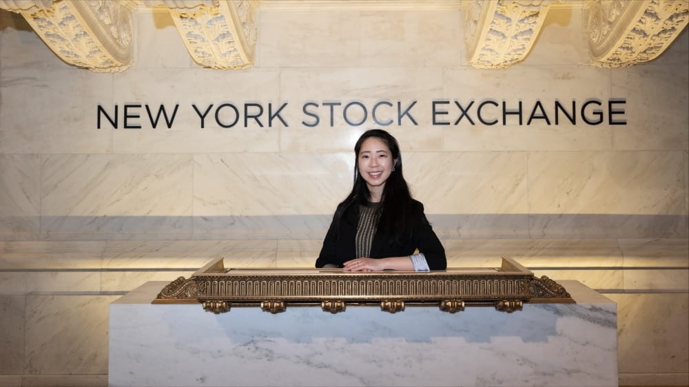 Woman standing in front of NYSE sign