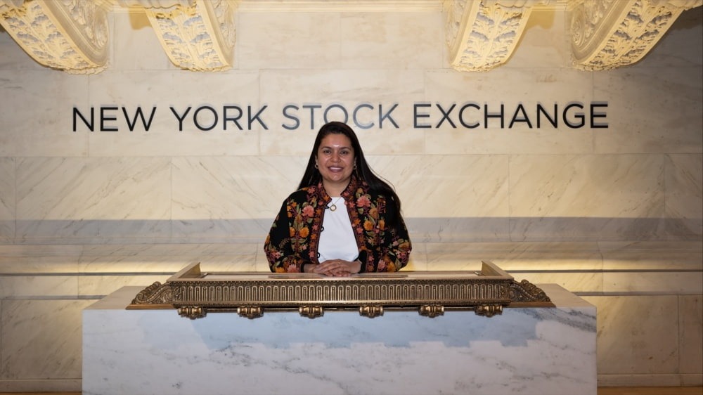 Woman standing in front of NYSE sign