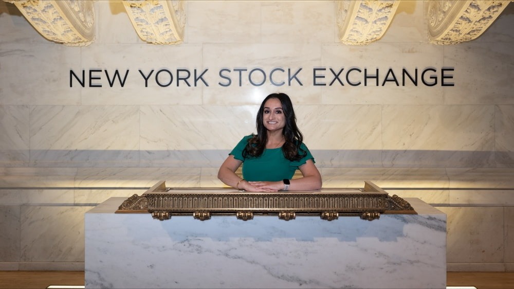Woman standing in front of NYSE sign