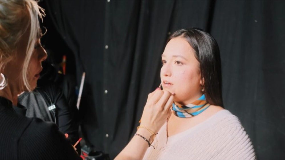 Woman getting lip gloss put on